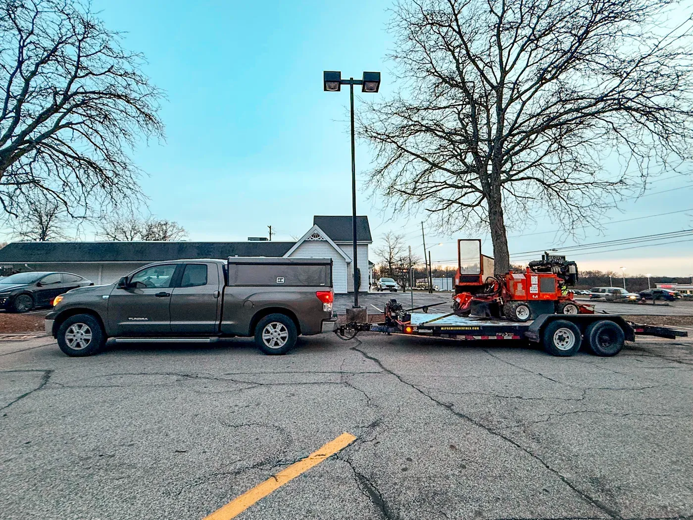 Truck towing the stump grinder on a trailer