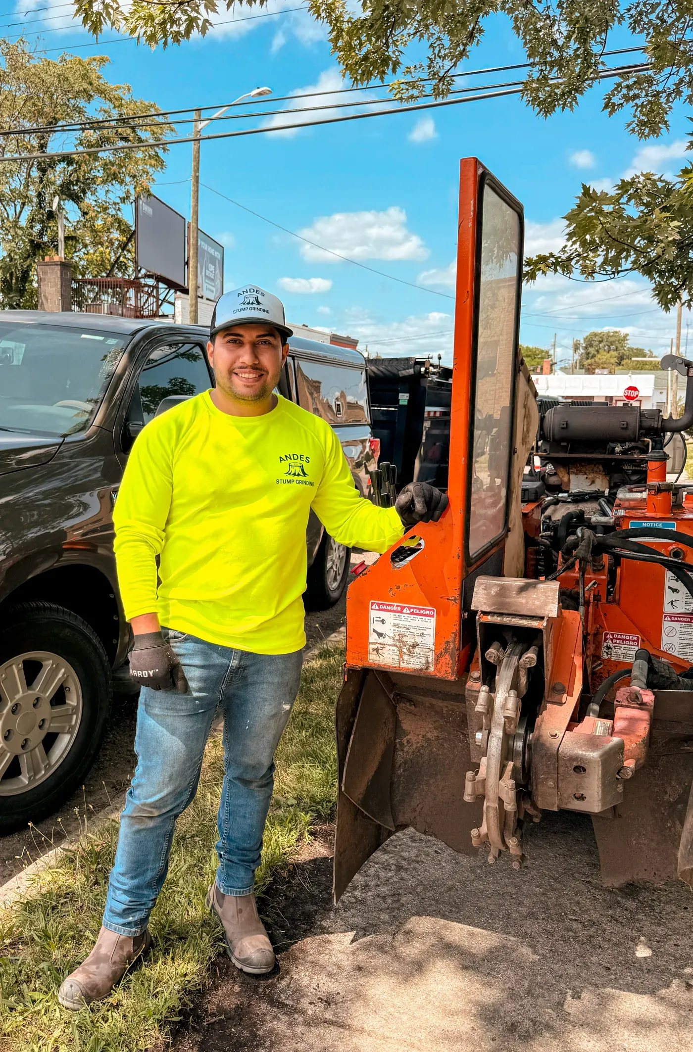 Alejandro standing next to the stump grinder